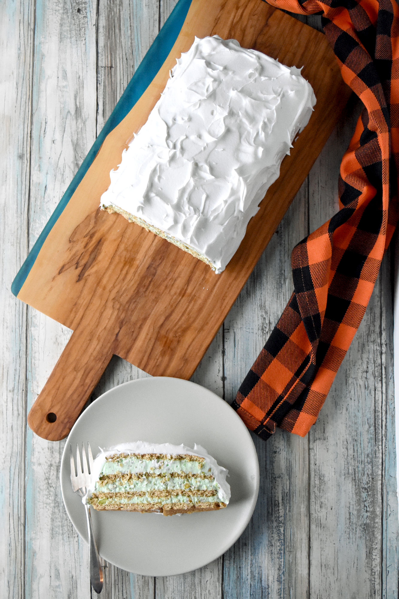Wicked Witch Icebox Cake is as green as the wicked witch, but tastes deliciously sweet and is full of pistachio flavor. It’s a quick and easy dessert to whip up for your Halloween parties. #HalloweenTreatsWeek #iceboxcake #WickedWitch #pistachio