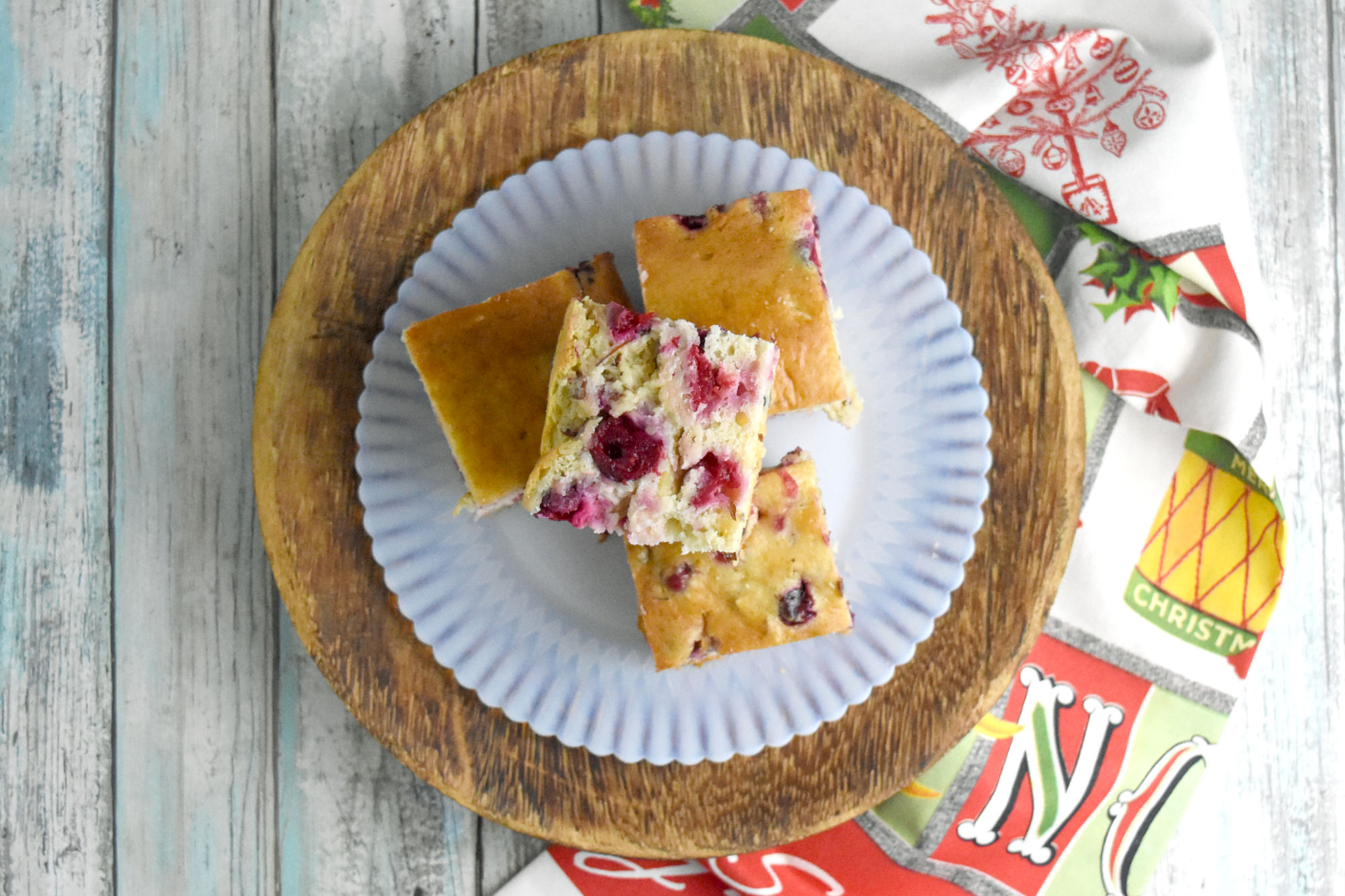Cranberry Snack Cake is a quick and delicious cake packed with tart cranberry flavor and a sweet vanilla and almond scented cake. It whips up in no time with fresh or frozen cranberries. #CranberryWeek #cranberry #snackcake #cranberrysauce #easyrecipe