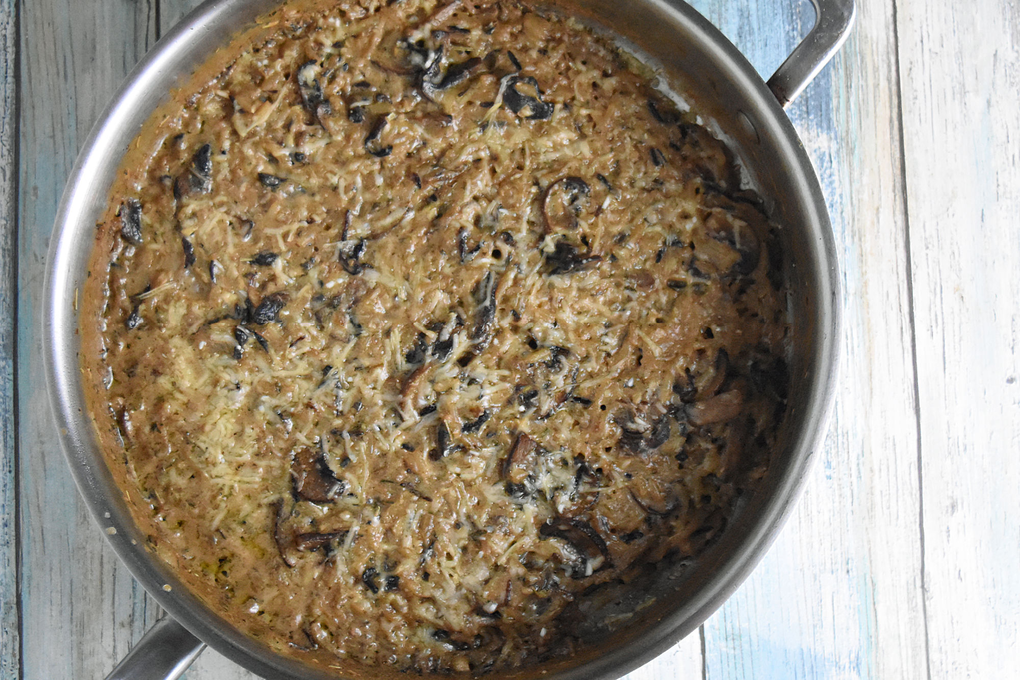 Mushroom and Wild Rice Casserole is packed with mushrooms and cheese.  It’s a quick recipe using boxed rice pilaf mix and cream of mushroom soup.  But there’s no denying it tastes totally homemade. #HolidaySideDishes #ricepilaf #bakedrice #cheesyrice #easyrecipe #sidedish #HolidayRecipe