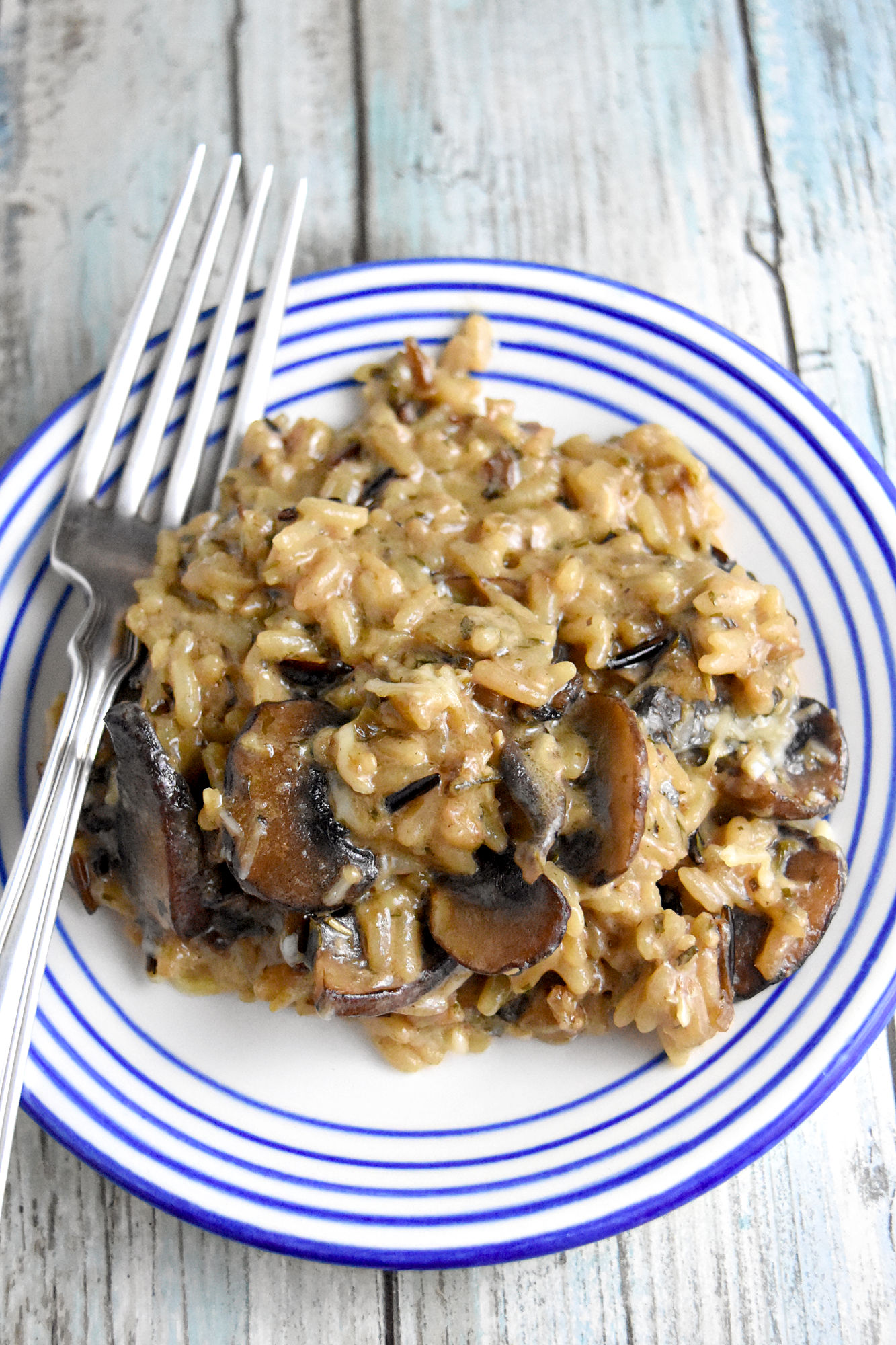 Mushroom and Wild Rice Casserole is packed with mushrooms and cheese.  It’s a quick recipe using boxed rice pilaf mix and cream of mushroom soup.  But there’s no denying it tastes totally homemade. #HolidaySideDishes #ricepilaf #bakedrice #cheesyrice #easyrecipe #sidedish #HolidayRecipe
