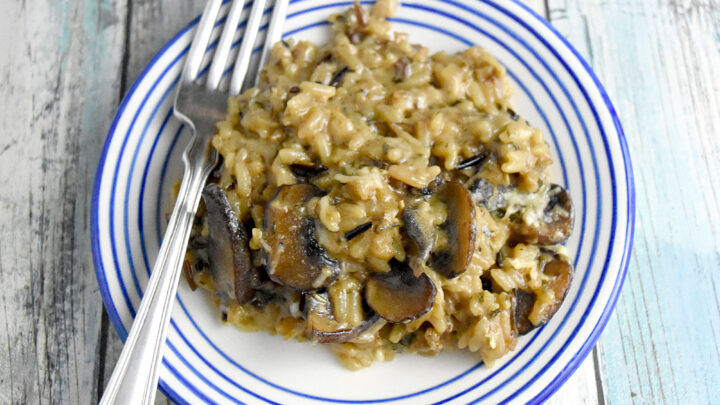 Mushroom and Wild Rice Casserole is packed with mushrooms and cheese. It’s a quick recipe using boxed rice pilaf mix and cream of mushroom soup. But there’s no denying it tastes totally homemade. #HolidaySideDishes #ricepilaf #bakedrice #cheesyrice #easyrecipe #sidedish #HolidayRecipe