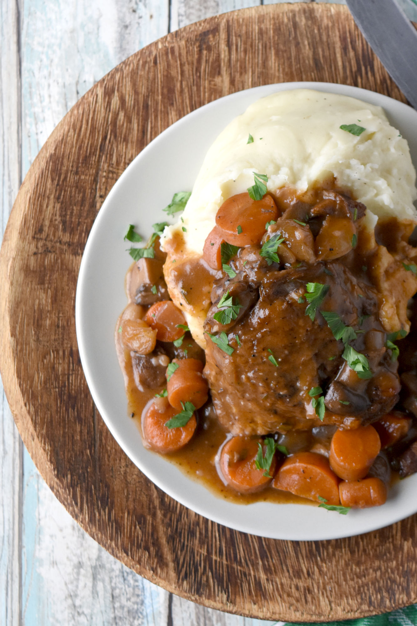 Classic Coq au Vin has all the rich flavors of the vintage recipe but easy enough for a weeknight dinner. With a little prep work, this is on the table in under 45 minutes. #OurFamilyTable #coqauvin #comfortfood #Frenchrecipe #chickenrecipe #classicrecipe #rustic