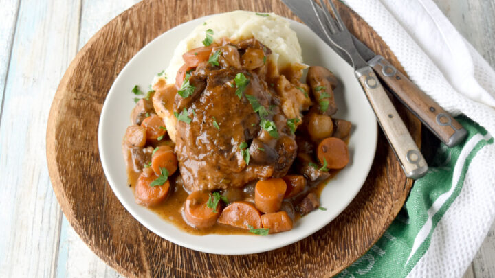 Classic Coq au Vin has all the rich flavors of the vintage recipe but easy enough for a weeknight dinner. With a little prep work, this is on the table in under 45 minutes. #OurFamilyTable #coqauvin #comfortfood #Frenchrecipe #chickenrecipe #classicrecipe #rustic