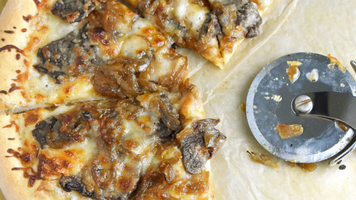 /Steak and Caramelized Onion Pizza is simple to make. The steak is cooked on the pizza which makes it tender and delicious with the caramelized onions. #OurFamilyTable #pizza #steakpizza #caramelizedonionpizza #steakandonions