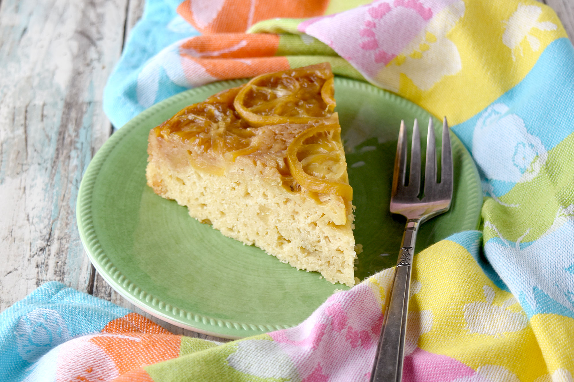 Meyer Lemon Upside Down Cake is super simple to make and tastes lemony and delicious. The cake is rustic with flecks of candied ginger throughout for a pleasant surprise.  #SpringSweetsWeek #Meyerlemon #lemoncake #upsidedowncake