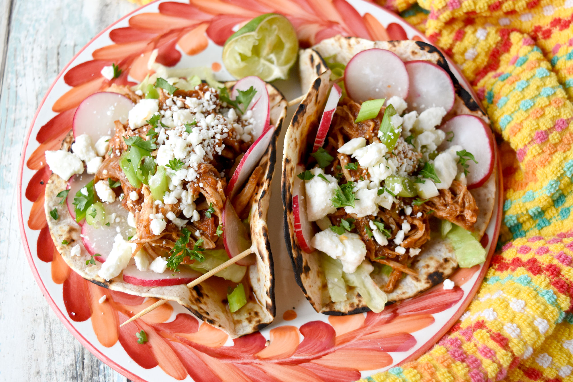 These Chicken Tinga Tacos cook up in the pressure cooker and taste like you traveled to Mexico. The chicken cooks in a chipotle tomato sauce packed with flavors. #OurFamilyTable #CincodeMayo #chickentinga #chickentacos #tingataco
