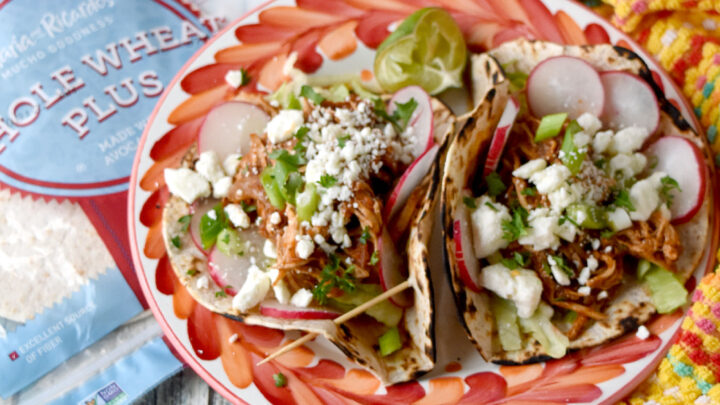 These Chicken Tinga Tacos cook up in the pressure cooker and taste like you traveled to Mexico. The chicken cooks in a chipotle tomato sauce packed with flavors. #OurFamilyTable #CincodeMayo #chickentinga #chickentacos #tingataco