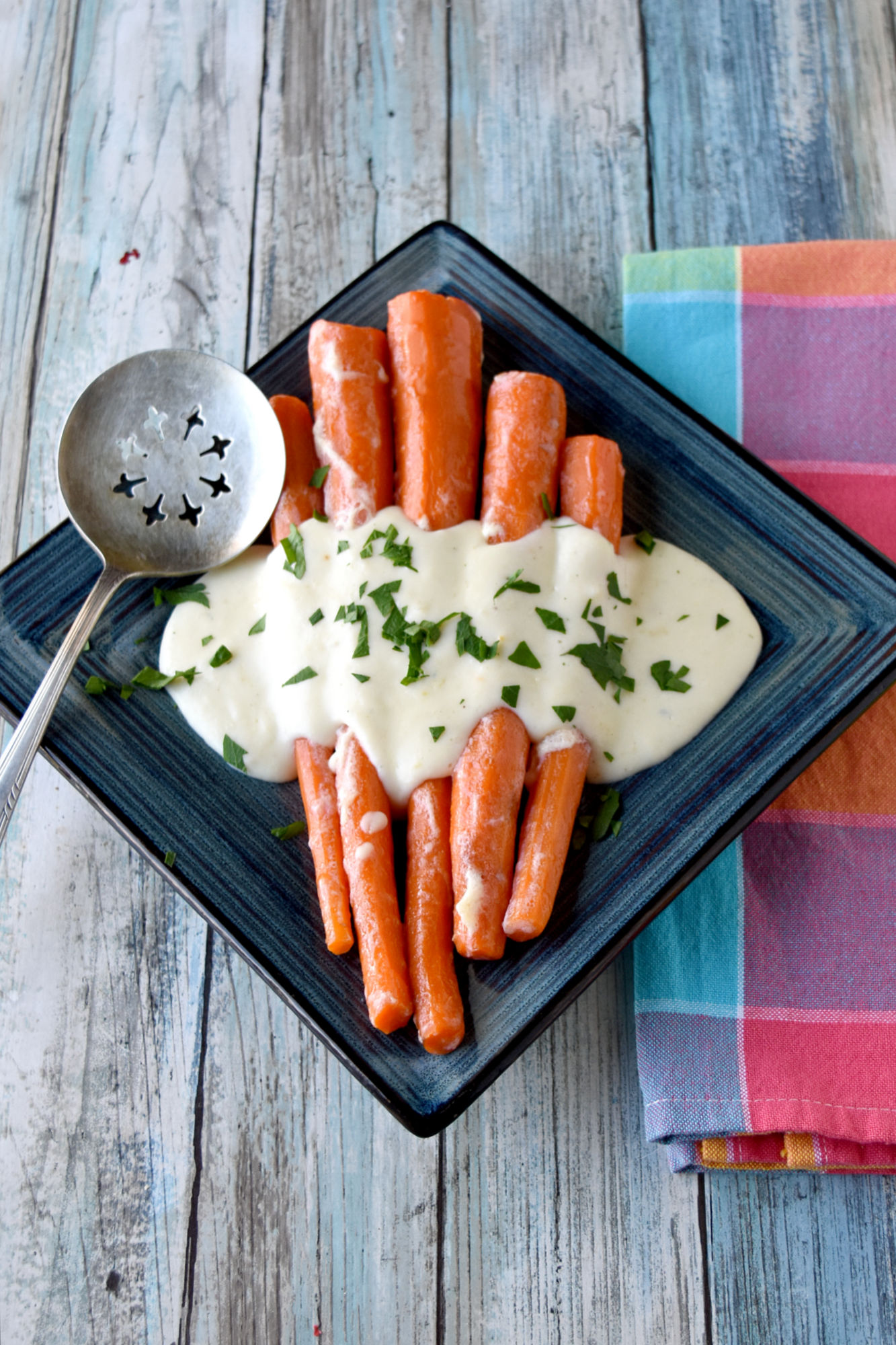Irish Buttered Carrots, also called (Slieve Na Mbam) is a simple dish that tastes delicious. Simmered in milk and butter, they’re sweet, butter, and packed with flavor.  #OurFamilyTable #easyrecipe #carrotrecipe #Irishrecipe