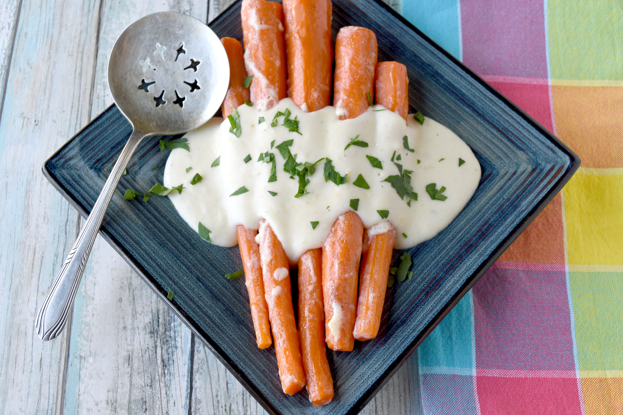 Irish Buttered Carrots, also called (Slieve Na Mbam) is a simple dish that tastes delicious. Simmered in milk and butter, they’re sweet, butter, and packed with flavor.  #OurFamilyTable #easyrecipe #carrotrecipe #Irishrecipe