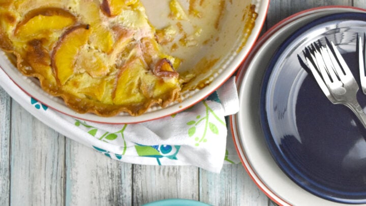 Fresh Peach Custard Pie has summer sweet peaches surrounded by a creamy sweet custard filling. The ingredients are simple but combine to make an irresistible pie your family will love. #custardpie #freshpeaches #inseasonpeaches #OhSayCanYouEB #sponsored #onlyfeedmeEB #madewithEB @egglandsbest