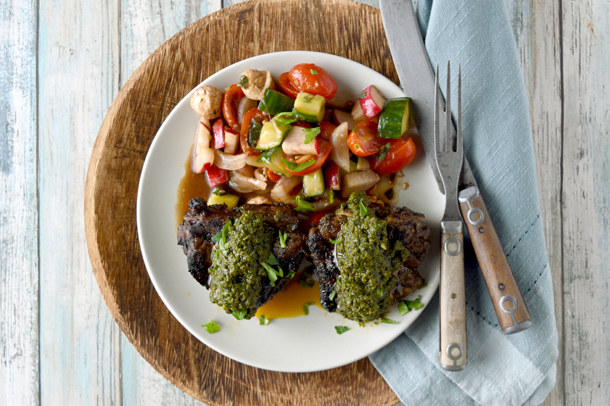 Green Harissa Grilled Lamb Chops have an herb filled delicious sauce with a kick on top of perfectly grilled lamb chops. This green harissa contains spinach, parsley, mint, and oregano and no cilantro. #HerbWeek #greenharissa #grilledlamb #spicysauce #freshherbs
