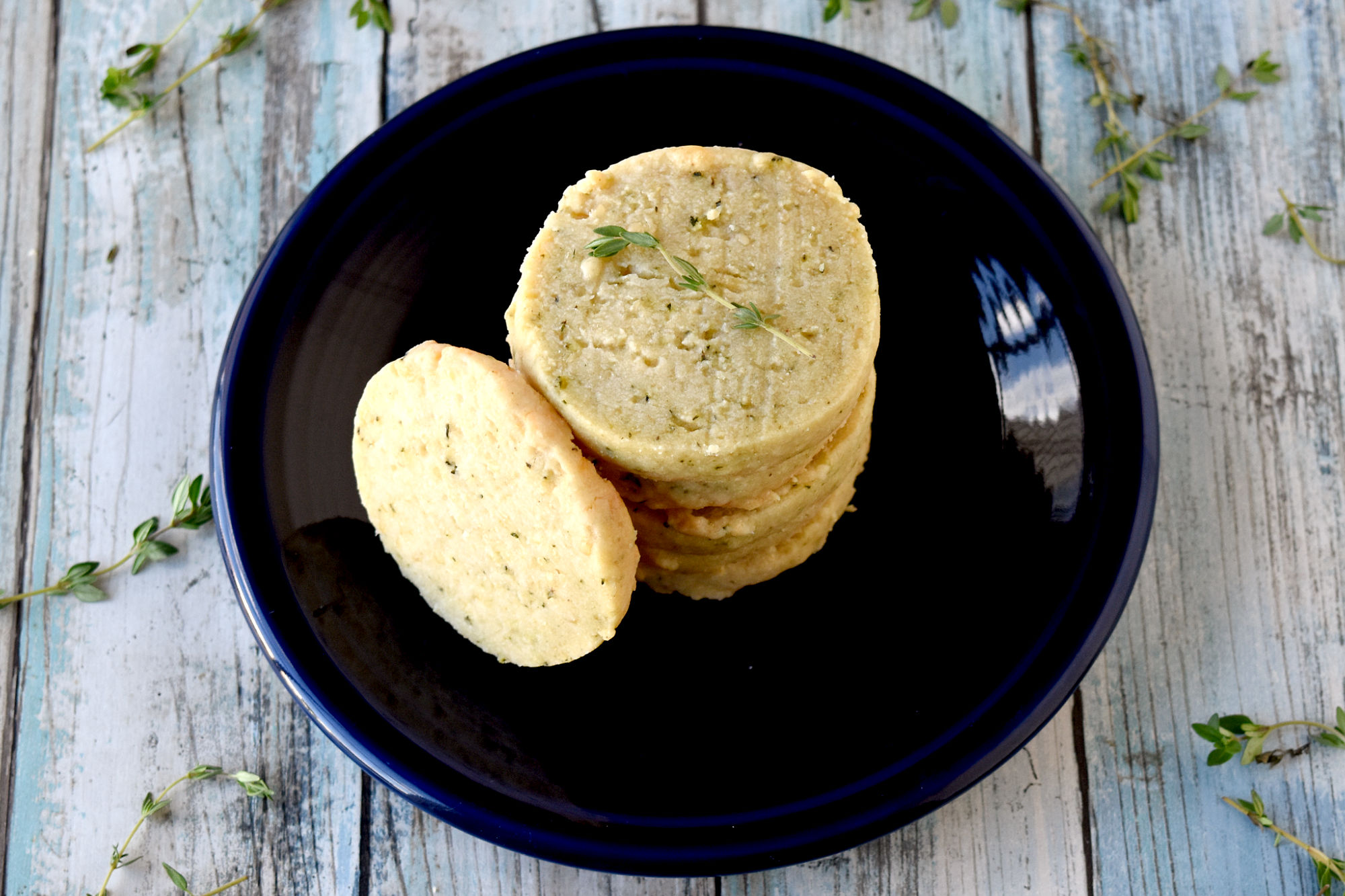 Gruyère and Thyme Shortbread Crackers are simple to make but taste simply delicious. Your guests will think they’re sweet cookies when you set them out before dinner but be surprised when they’re not. #HerbWeek #shortbread #homemadecrackers #Gruyerecheese
