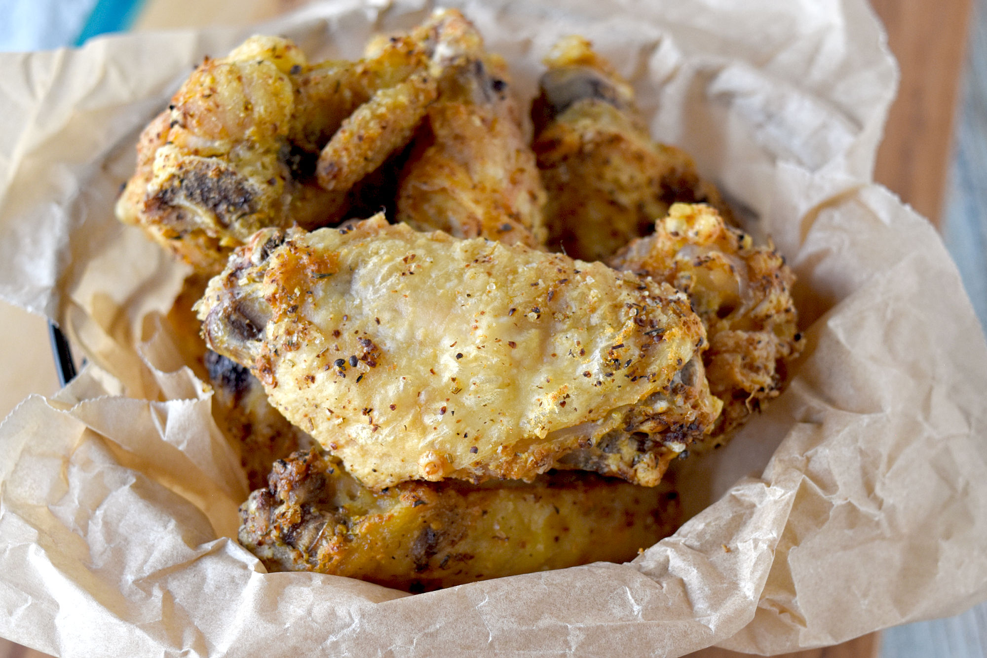 These are the Crispest Air Fryer Chicken Wings I’ve ever made. They have a crunchy outside and a juicy, tender inside. An easy and delicious snack for game day! #OurFamilyTable #airfryer #crispywings #crispyairfryerwings #chickenwings