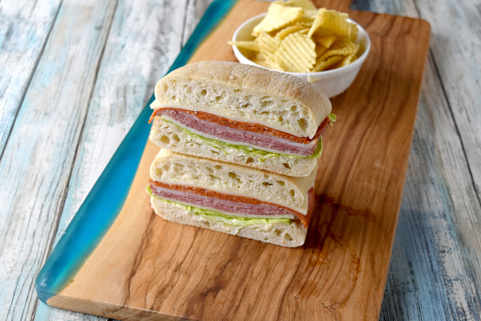 Pressed Picnic Sandwiches are fun to make, easily to customize, and not messy! They’re a fun make ahead recipe for any picnic or outdoor adventure.  #OurFamilyTable #pressedsandwich #sandwichrecipe #picnicsandwich #picnicbasket