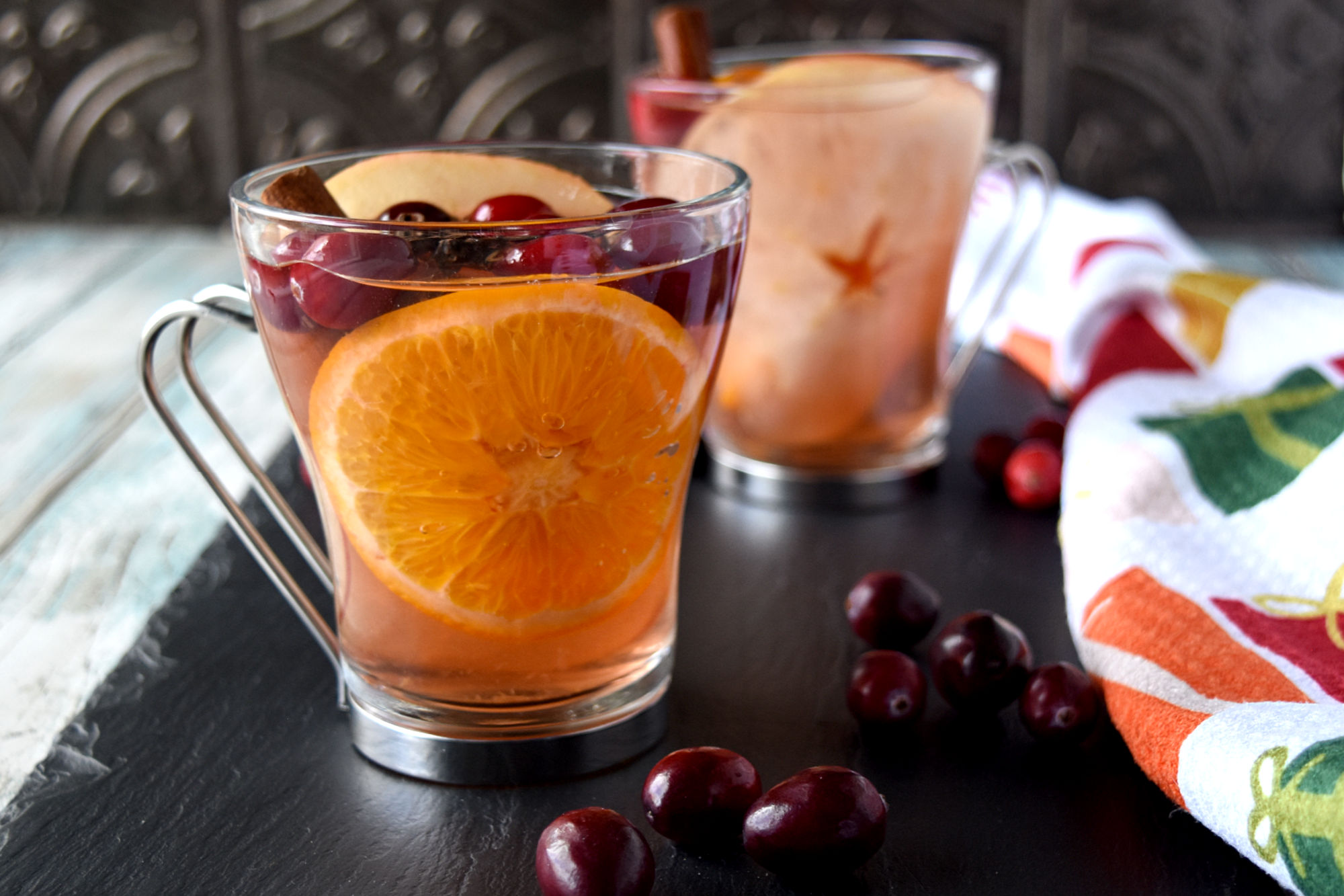 Looking to add a touch of elegance and flavor to your upcoming holiday gathering? This cranberry spiced sangria recipe will leave your guests begging for the recipe and asking for seconds. #CranberryWeek #sangria #wintersangria #spicedsangria #rosesangria
