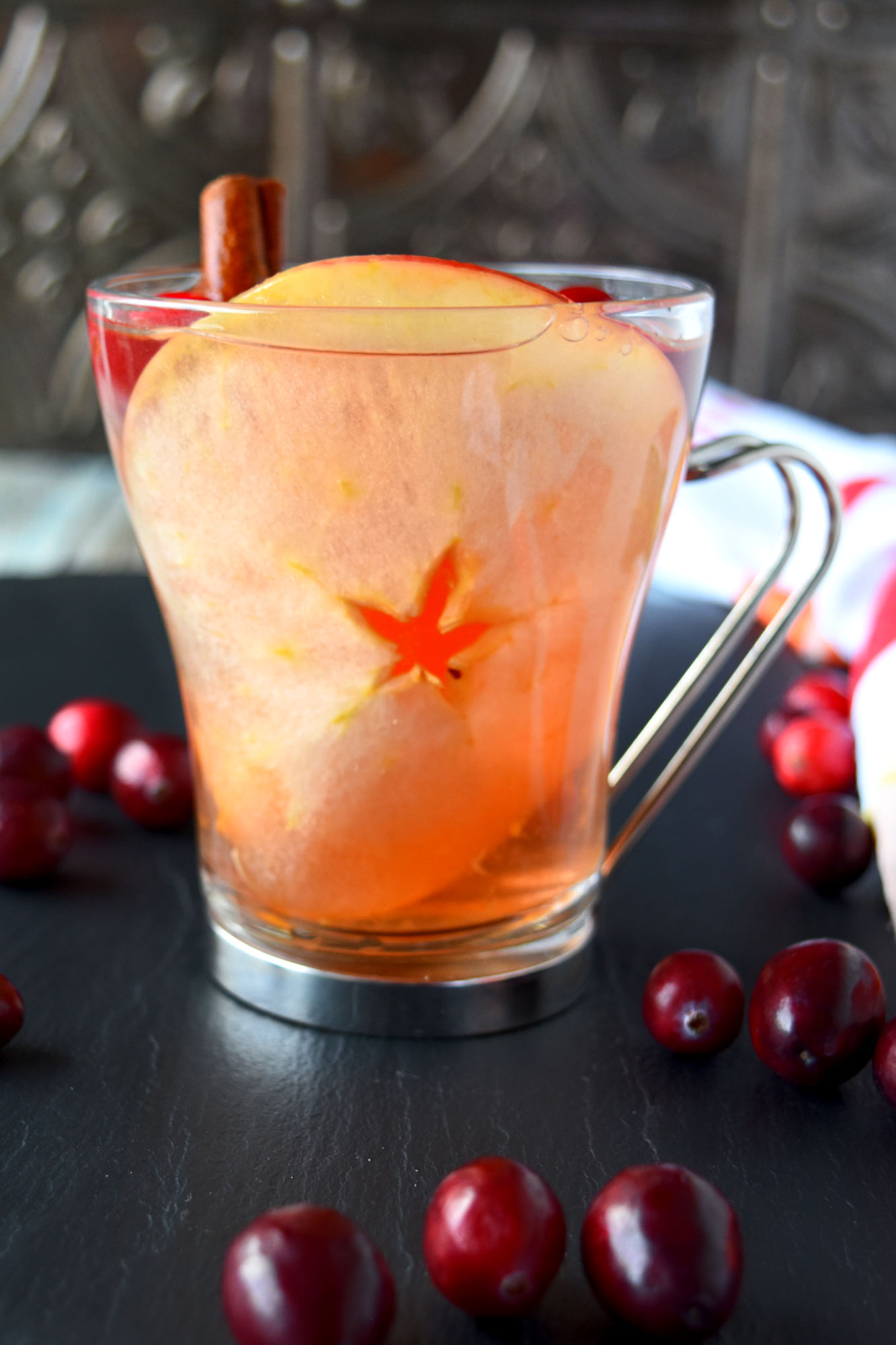 Looking to add a touch of elegance and flavor to your upcoming holiday gathering? This cranberry spiced sangria recipe will leave your guests begging for the recipe and asking for seconds. #CranberryWeek #sangria #wintersangria #spicedsangria #rosesangria
