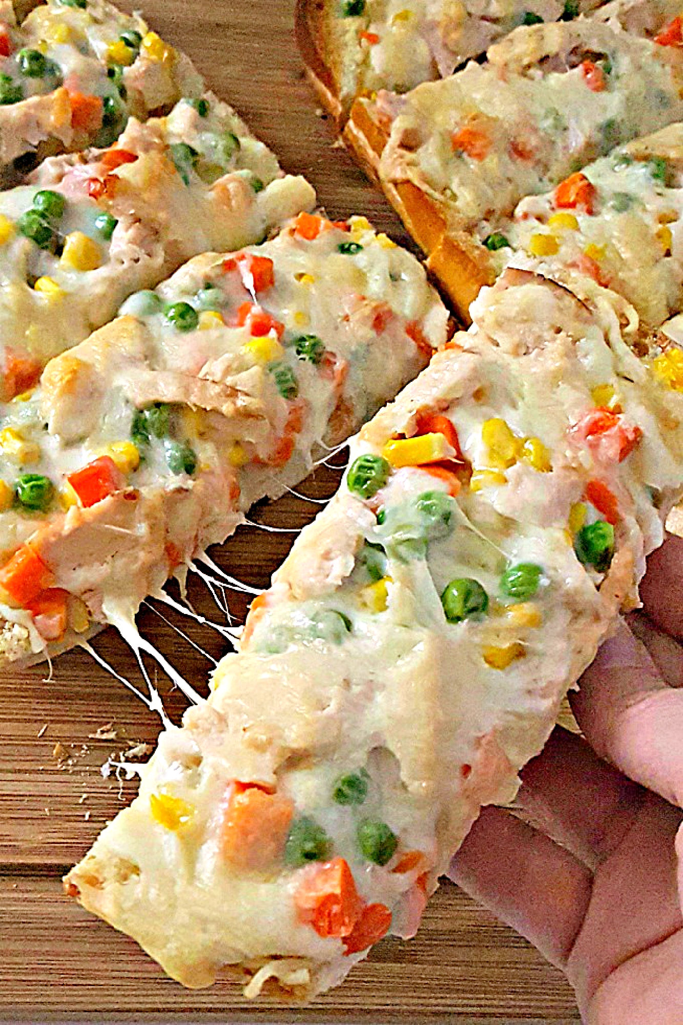 Get ready for a flavor explosion with Chicken Pot Pie French Bread Pizza.  It's the ultimate comfort food mashup. Trust us, one bite and you'll be hooked. #OurFamilyTable #ChickenPotPiePizza #FrenchBreadPizza #EasyDinnerRecipes #HomemadeComfortFood #FamilyDinnerIdeas
