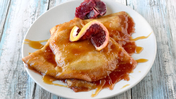 Satisfy your sweet tooth with the ultimate indulgence - #BloodOrange Crepe Suzette! A citrus twist on a classic dessert that is sure to brighten up your day. #SpringSweetsWeek #dessertlover #foodie #CitrusCreations #SweetAndTangy #FruitDesserts #FrenchInspiredTreats #FlamingCrepes