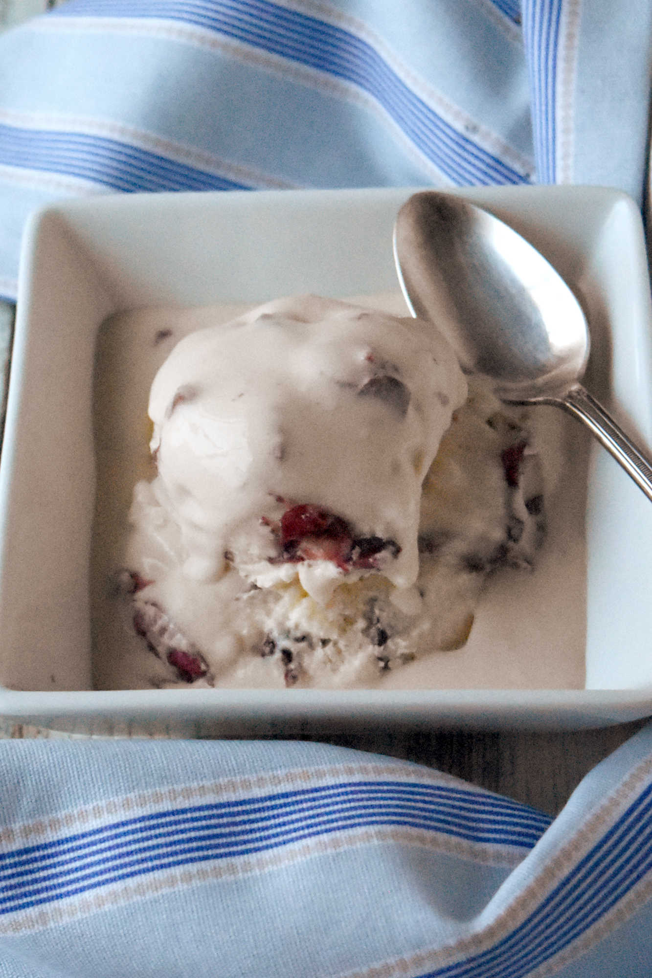 Elevate your ice cream game with this delicious cherry pie mascarpone ice cream. Trust us, it's worth the brain freeze.
July is Ice Cream Month. And July 9th is Ice Cream Social Day. That’s why I’m sharing this cherry pie mascarpone ice cream. It was either this or beer and pretzel ice cream. I just couldn’t find a single micro brew to use for the ice cream. So, I went with option two in this cherry ice cream.
I made a pistachio mascarpone ice cream a little while ago. It was rich, creamy, and oh so delicious. And the mascarpone helped keep the ice cream from freezing rock hard. I could somewhat easily scoop it out the next day. Since I had success then, I thought I’d try adding mascarpone to this ice cream recipe, too.
Where does ice cream come from?
The story of ice cream’s invention is woven through centuries and across continents. Like most recipes, its true origins are hidden in legend and innovation. Ancient Chinese emperors are said to have enjoyed frozen treats made from milk and rice. They chilled this treat with snow brought down from the mountains. The Persian empire made sharbat crafted from fruit, honey, and snow to cool the summer heat. Sounds like sorbet to me! The Renaissance Italians refined the idea further. They created gelato by blending milk, cream, sugar, and flavorings together.
By the 17th century, ice cream had reached France and then England. As with most cultural culinary creations, it became a favorite among royals and aristocrats. Over time, each culture added its own flair. And over time ice cream evolved from rare luxury to beloved everyday indulgence. There are more flavors than I can count. This is a reflection of how versatile and customizable this treat truly is.
Custard vs. Non-Custard Ice Cream
At the heart of every ice cream recipe lies a decision: custard-based or not? There are some purists who swear that only custard-based ice cream is TRUE ice cream. It is known as the French-style ice cream. This type of ice cream consists of a custard base made with egg yolks, sugar, and cream. This results in a rich, velvety texture.
Non-custard, or Philadelphia-style, skips the eggs in favor of simplicity and a lighter taste. The base in this ice cream omits the eggs and cooking time completely. It saves time, but can make for a harder scoop on the second day as there’s little fat to keep crystals from forming.
Ice Cream vs. Sorbet vs. Sherbet: What’s the Difference?
In the world of frozen desserts, these are sometimes used interchangeably, but each offers a distinct experience. Ice cream has a diary base at the very least. And can have a custard base with the addition of eggs. Sorbet has no dairy at all. It relies on fruit and sugar or simple syrup making for a vibrant fruit treat. Sherbet is a combination of the two. It adds a little dairy to the fruit and sugar.
What is Mascarpone?
Mascarpone is a fresh, silky cheese beloved for its subtle sweetness and creamy texture. It originated in from Lombardy, Italy. It is best known for being part of tiramisu. But this versatile cheese lends a depth to both sweet and savory dishes. Some use in cheesecake and some fold it into pasta. But when folded into ice cream, it brings a an exquisite creaminess that elevates every bite.
Tips for Keeping Your Ice Cream from Freezing Rock Solid
Homemade ice cream has a tendency to harden in the freezer, but you can keep your scoops soft and creamy with a few key strategies. I combined sugar and honey in this recipe. Honey doesn’t freeze solid. It just thickens thus making it a good way to keep your ice cream being rock solid. Another ingredient that doesn’t freeze is alcohol. Just a little goes a long way. A tablespoon of alcohol lowers the freezing point which prevents your cherry ice cream from freezing solid. Some swear by parchment on top of the ice cream, but that hasn’t necessarily worked for me.
The final trick I have not used yet. I forgot to buy some for this recipe. Xantham gum or guar gum. Both gums are stabilizers for ice cream. They improve the texture and prevent crystals from forming, which causes ice cream to be rock solid.
P6H
Guar gum is natural polysaccharide derived from guar beans. It acts as a thickening agent to and create a smoother, creamier ice cream. Xantham gum has similar properties, but it’s a polysaccharide produced by fermenting simple sugars with a specific bacterium.
Ingredients to make Cherry Pie Mascarpone Ice Cream
Pantry ingredients – sugar, honey, vanilla extract, salt
Refrigerator ingredients – eggs, milk, cream, mascarpone cheese, cherries, pie crust
Instructions to Make This Cherry Ice Cream Recipe
First, we start with making the custard base. Whip the yolks with the sugar and the honey until light and creamy. Stir in the milk, whipping cream, vanilla, and salt. Pour the mixture into a medium saucepan. Cook the custard on medium heat and stir every 3 to 5 minutes to keep the eggs from curdling. Coat the back of a spoon with the custard. Drag your finger down the back of the spoon. If the custard doesn’t fill in that line then it’s ready.
P7V
Strain the mixture through a fine mesh strainer to catch and bits of cooked egg. Let the custard cool in the fridge. Or prepare a larger bowl with ice to cool it down faster. When it’s cool enough pour the custard in your ice cream maker. Follow the instructions for your ice cream maker to mix the ice cream.
While the custard is cooling, cook the pie crust at 450 for 7 to 10 minutes or until golden brown. When the ice cream is finished mixing, stir in the chopped cherries. Break the pie crust up into pieces and stir those into the ice cream. Spoon the ice cream into an airtight container. Put plastic wrap on top of the ice cream, like you do with custard, before sealing the container. Chill the ice cream for 2 to 4 hours or overnight. Garnish with cherries and pie crust pieces before serving.
P8H
What does cherry pie mascarpone ice cream taste like?
It is a rich and creamy custard ice cream that is sweet with a lovely flavor of vanilla. The mascarpone makes the ice cream even more creamy and rich. It is a luxuriously smooth ice cream recipe that is irresistible. It’s not your regular store brought ice cream. You can taste the richness that the mascarpone brings to the party.
I used frozen sweet cherries for this ice cream. They were not overly sweet and had a hint of tart that goes well with the rich, vanilla flavored custard ice cream base. If you have fresh cherries that are ripe and sweet, feel free to use those. Then there’s the salty and crunchy bits of pie crust that rounds out all the flavors in this ice cream. It’s a fun ice cream that’s also rich and luxurious.
