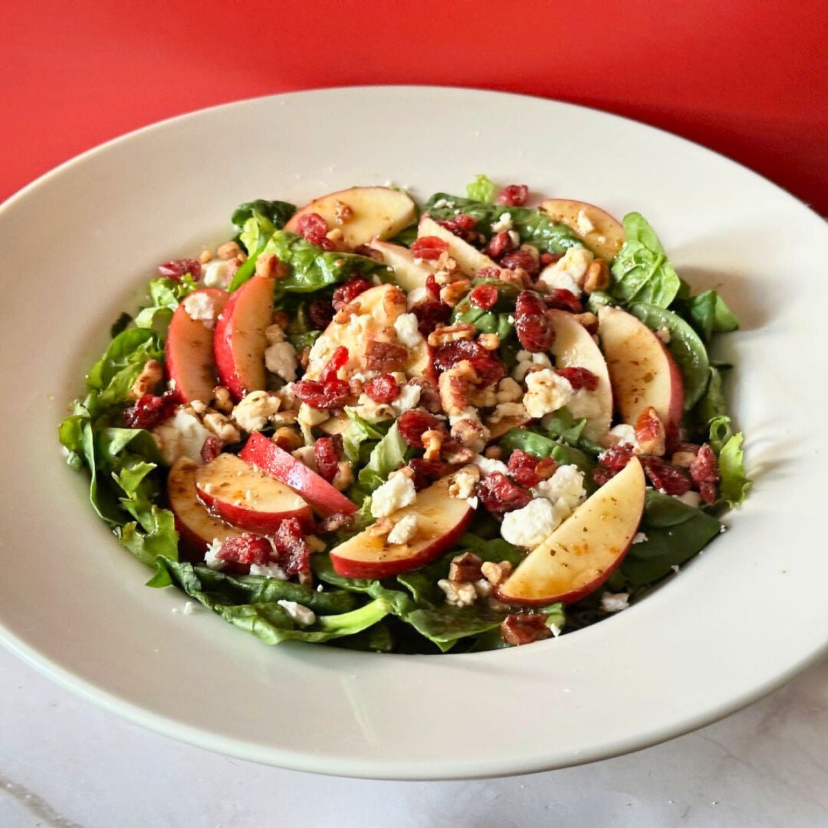 This apple gorgonzola salad with balsamic vinaigrette combines crisp apples, gorgonzola, pecans and dried cranberries in a fresh, tasty salad.
