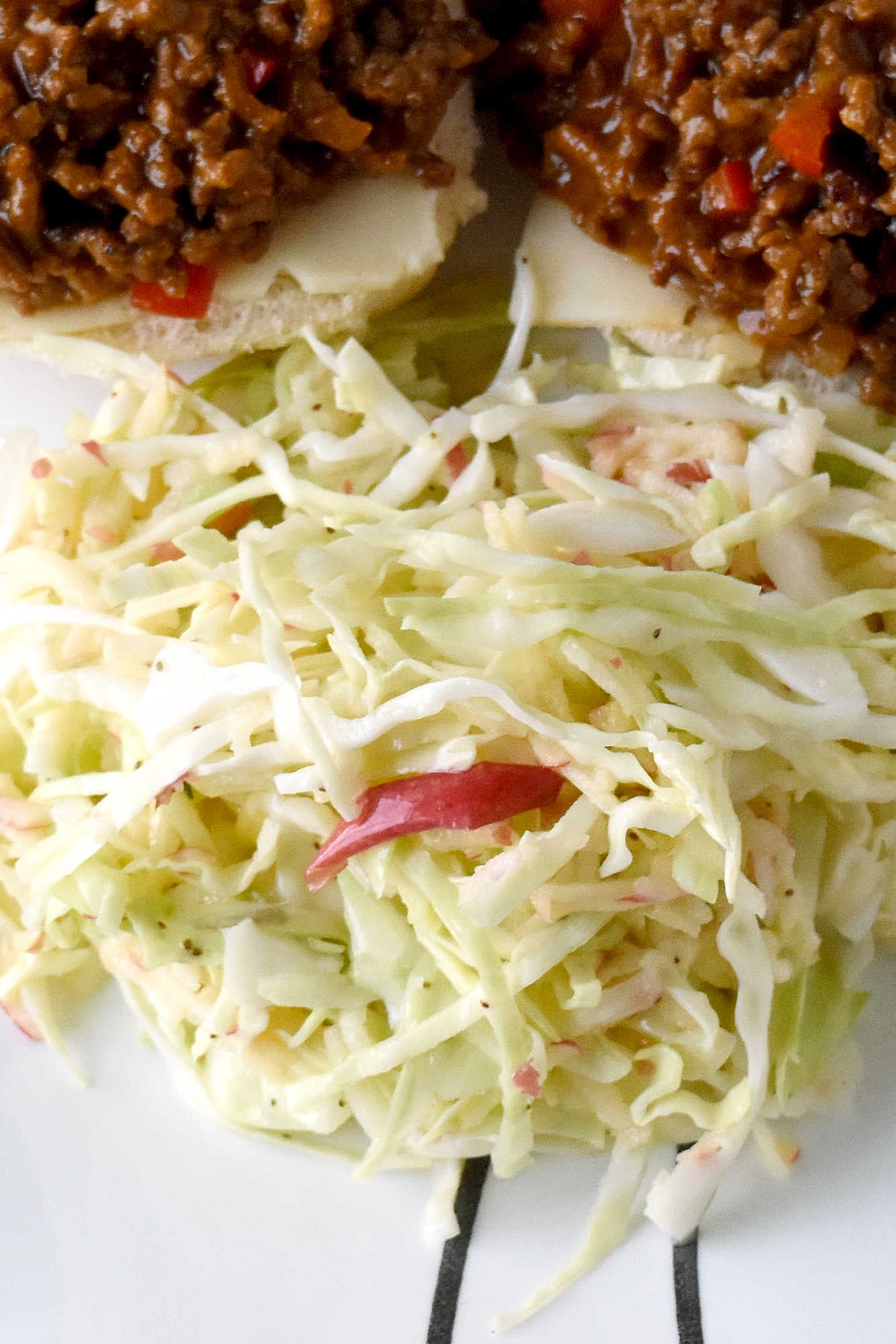Upgrade your coleslaw game with a crunchy and refreshing easy apple slaw. Perfect for tailgating, potlucks, or as a side dish for any meal.   #HealthyEatsWithEase #NoFussFruitSalad #EffortlessAppleSlaw #QuickAndNutritious #FruitAndVeggieFix