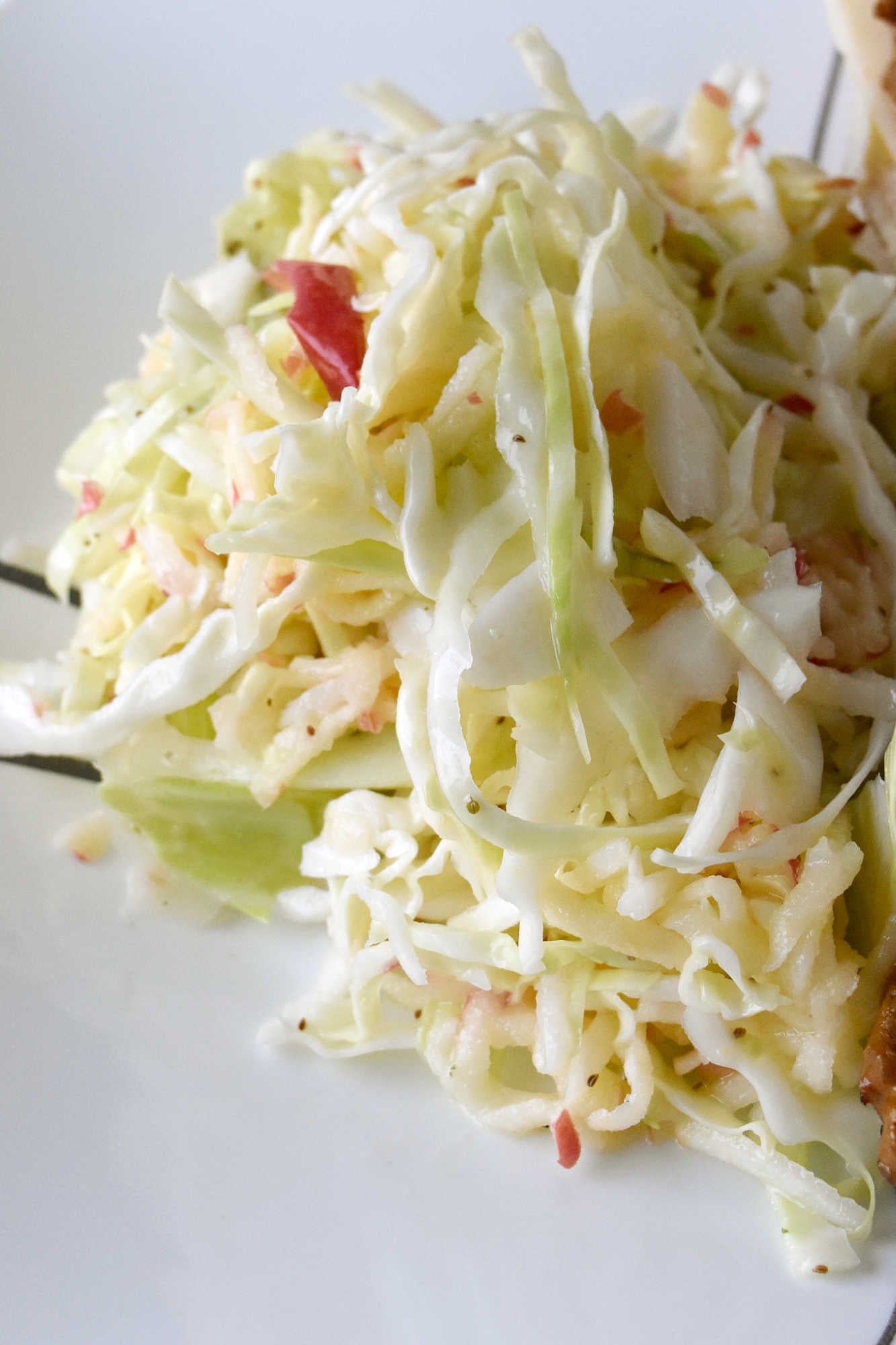 Upgrade your coleslaw game with a crunchy and refreshing easy apple slaw. Perfect for tailgating, potlucks, or as a side dish for any meal.   #HealthyEatsWithEase #NoFussFruitSalad #EffortlessAppleSlaw #QuickAndNutritious #FruitAndVeggieFix