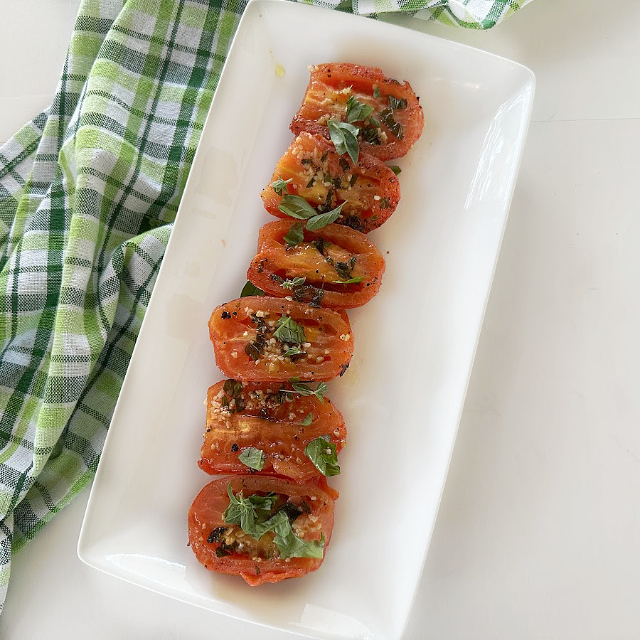 Garlic Grilled Tomatoes highlight the best of fresh summer produce. Grill fresh summer tomatoes that are drizzled with a garlic and herb-infused olive oil to bring out the robust flavors of the tomatoes.