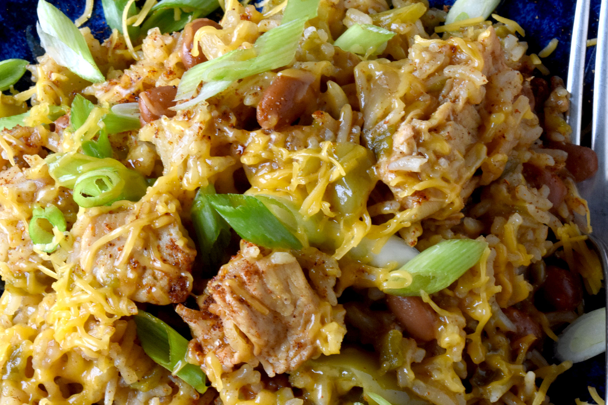 Raise your hand if you love a good one-pot meal! This Green Chile Chicken and Rice is the perfect combination of spicy and savory. Plus it's minimal clean up, maximum flavor! #OurFamilyTable #WeeknightDinner #GreenChileChicken #RiceRecipes #EasyWeeknightDinner #SpicyEats #GreenChileEats #OnePotMeals #SouthwestFlavors #RiceBowls #SpicySatisfaction