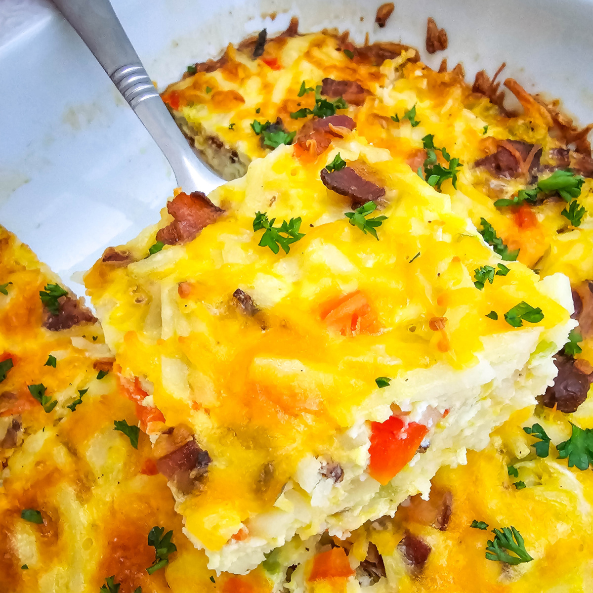 Features a layer of shredded hashbrowns, crisp bacon, colorful bell peppers, and plenty of cheddar cheese all baked to golden perfection with a rich egg custard mixture.