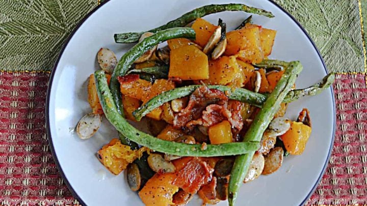Tender green beans and sweet butternut squash are roasted to perfection, then tossed with crispy bacon and crunchy pumpkin seeds for a sweet and side dish that will steal the show.