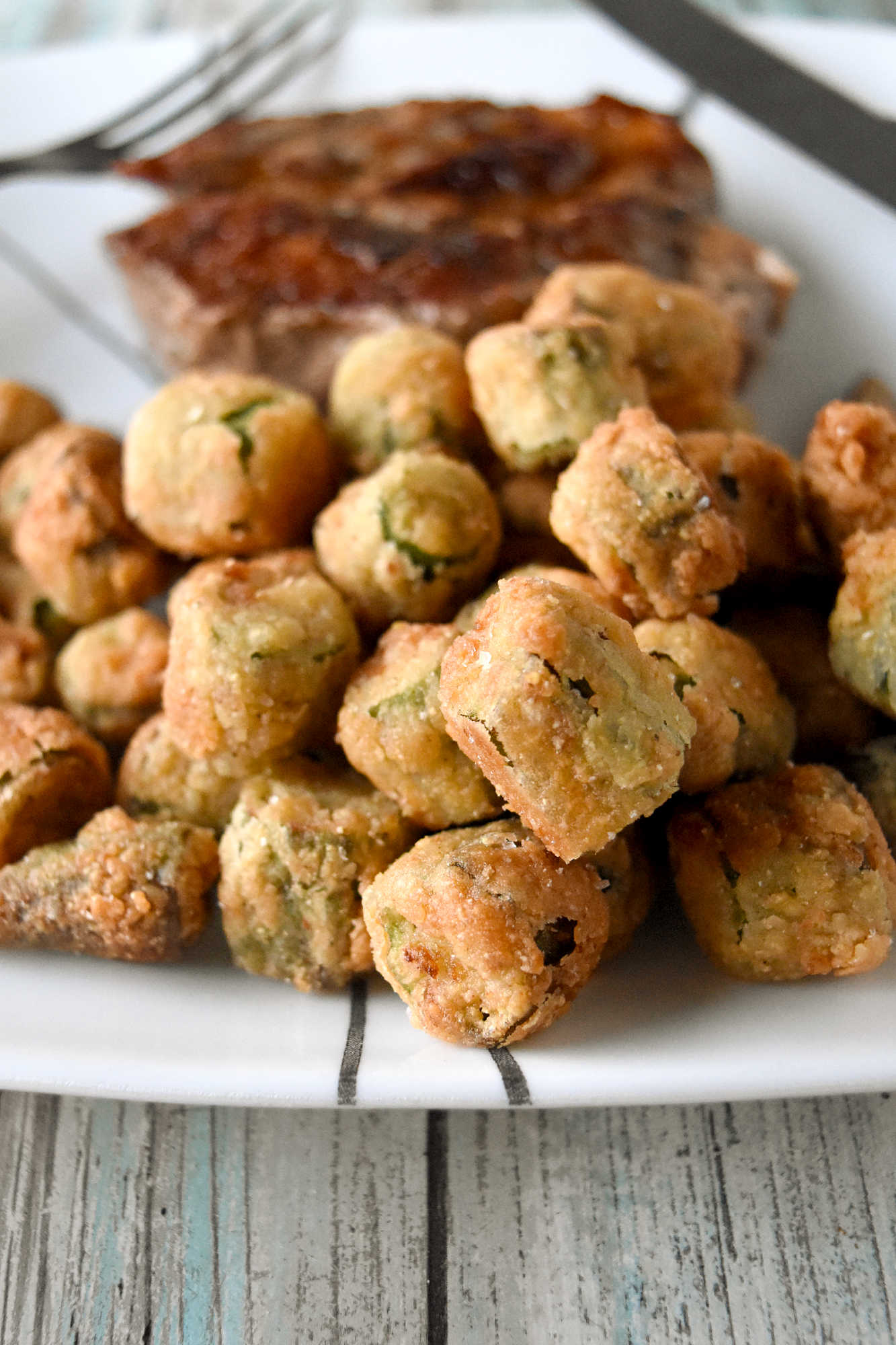Crispy southern fried okra instantly brings a touch of southern charm to your table. These crunchy, golden bites are the perfect excuse to linger a little longer around the holiday table. #HolidaySideDish #southernfoodlove #okralove #friedfoodheaven #southernfavourites #southerncookingdelights
