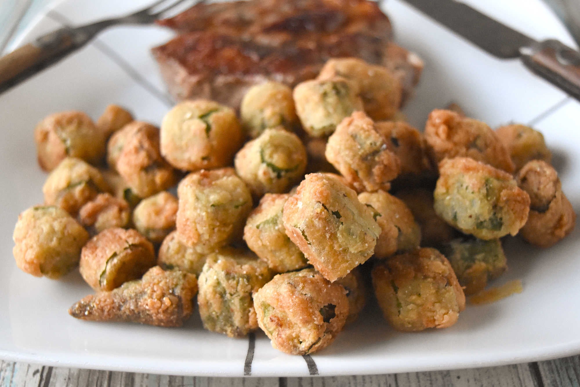 Crispy southern fried okra instantly brings a touch of southern charm to your table. These crunchy, golden bites are the perfect excuse to linger a little longer around the holiday table. #HolidaySideDish #southernfoodlove #okralove #friedfoodheaven #southernfavourites #southerncookingdelights