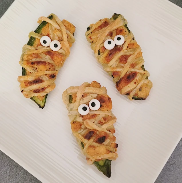 Get ready for Halloween with these fun Mummy Jalapeño Poppers! A deliciously cheesy and spicy treat that's perfect for your holiday celebrations!