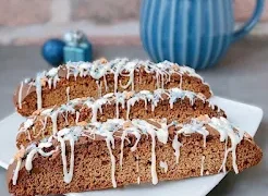 Crisp, spiced Gingerbread Biscotti with molasses and crystallized ginger. Perfect for holiday gifting, coffee dunking, or festive treats.