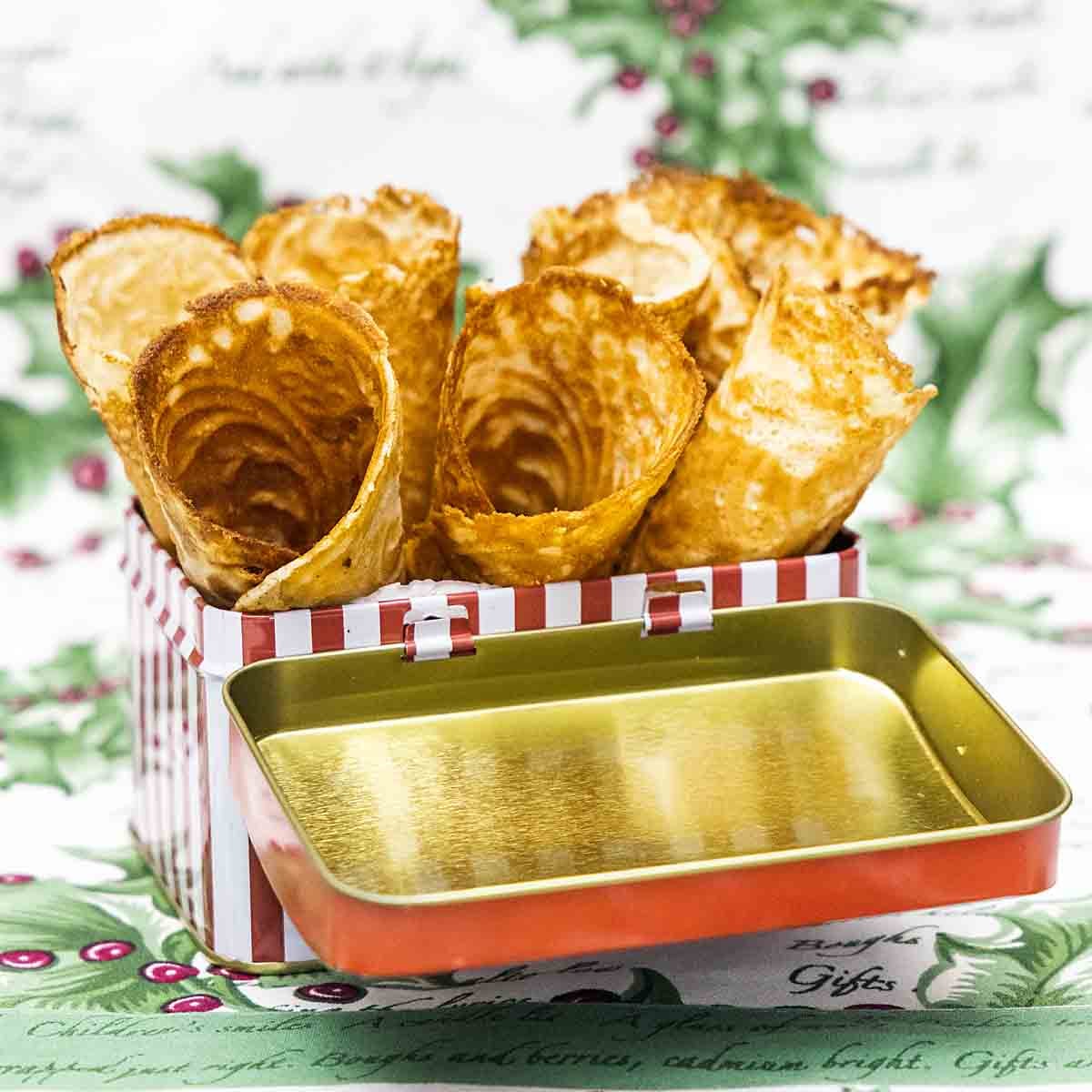 A crisp waffle cookie, rolled into a cone shape and filled with whipped cream, makes a Norwegian Krumkake a fun holiday treat!