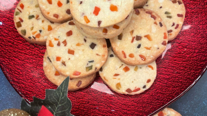 These eggless tutti fruity cookies are buttery, delicious, nutty, festive shortbread cookies with specks of jewel toned tutti fruity.