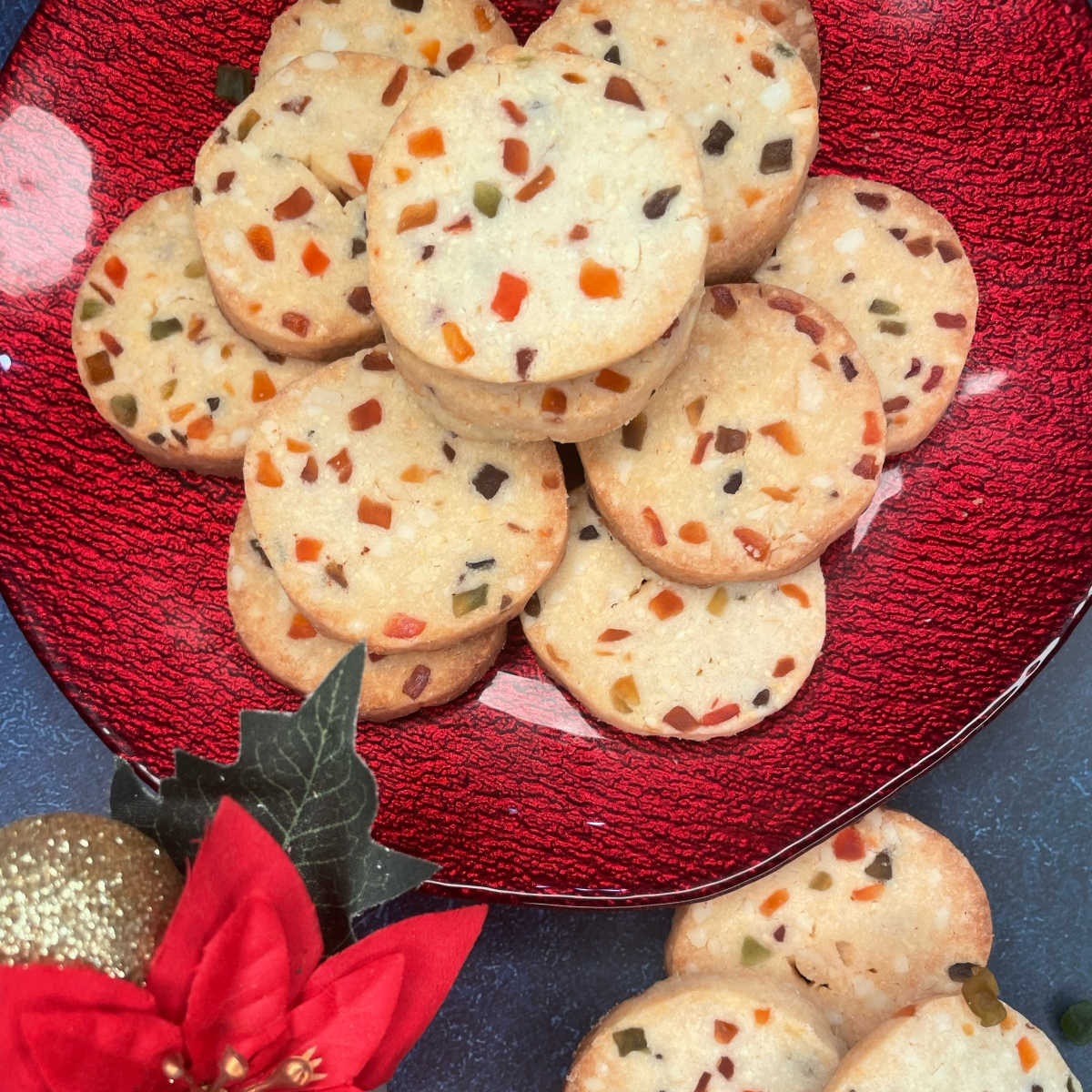 These eggless tutti fruity cookies are buttery, delicious, nutty, festive shortbread cookies with specks of jewel toned tutti fruity.