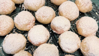 Tender cream cheese cookie surrounding a cherry and sprinkled with powdered sugar. A perfect addition to your Christmas Cookie tray.