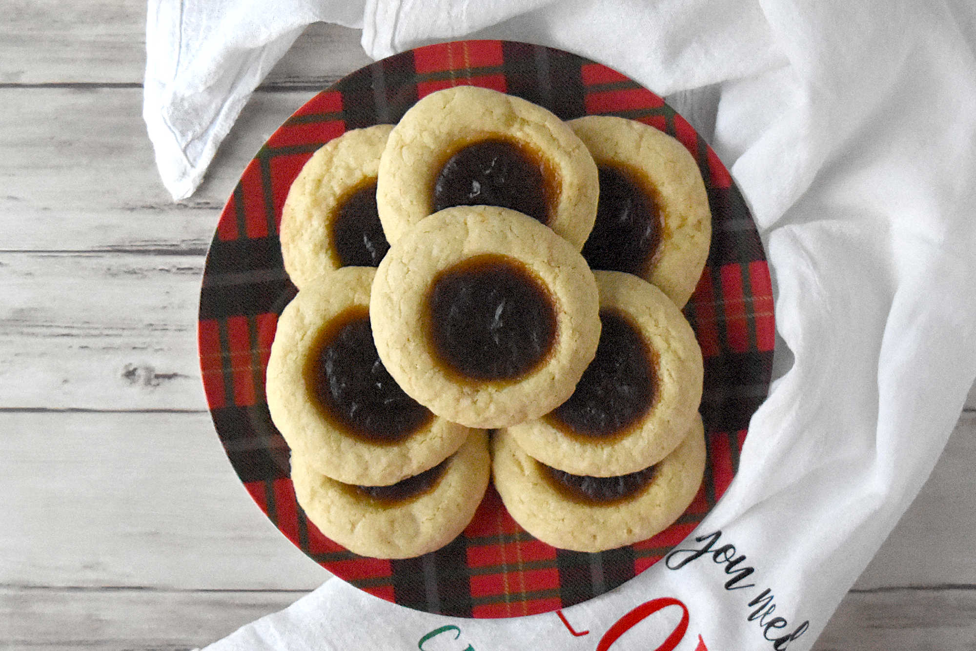 Pumpkin Pie Thumbprint Cookies take everything you love about holiday desserts and pack it into a sweet, bite sized treat.  They are perfect for anyone who cannot decide between pie and cookies. #ChristmasCookies #PumpkinPieThumbprintCookies #FallBakingDelights #HolidayBakingGoals #CookieLoversUnite #EasyDessertRecipes
