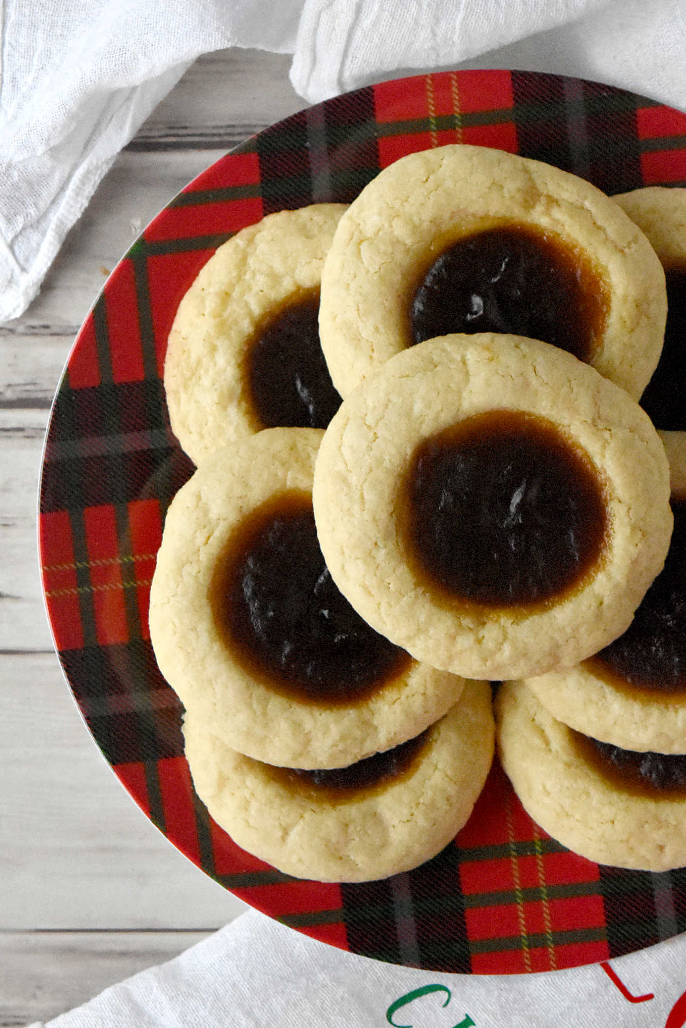 Pumpkin Pie Thumbprint Cookies take everything you love about holiday desserts and pack it into a sweet, bite sized treat.  They are perfect for anyone who cannot decide between pie and cookies. #ChristmasCookies #PumpkinPieThumbprintCookies #FallBakingDelights #HolidayBakingGoals #CookieLoversUnite #EasyDessertRecipes