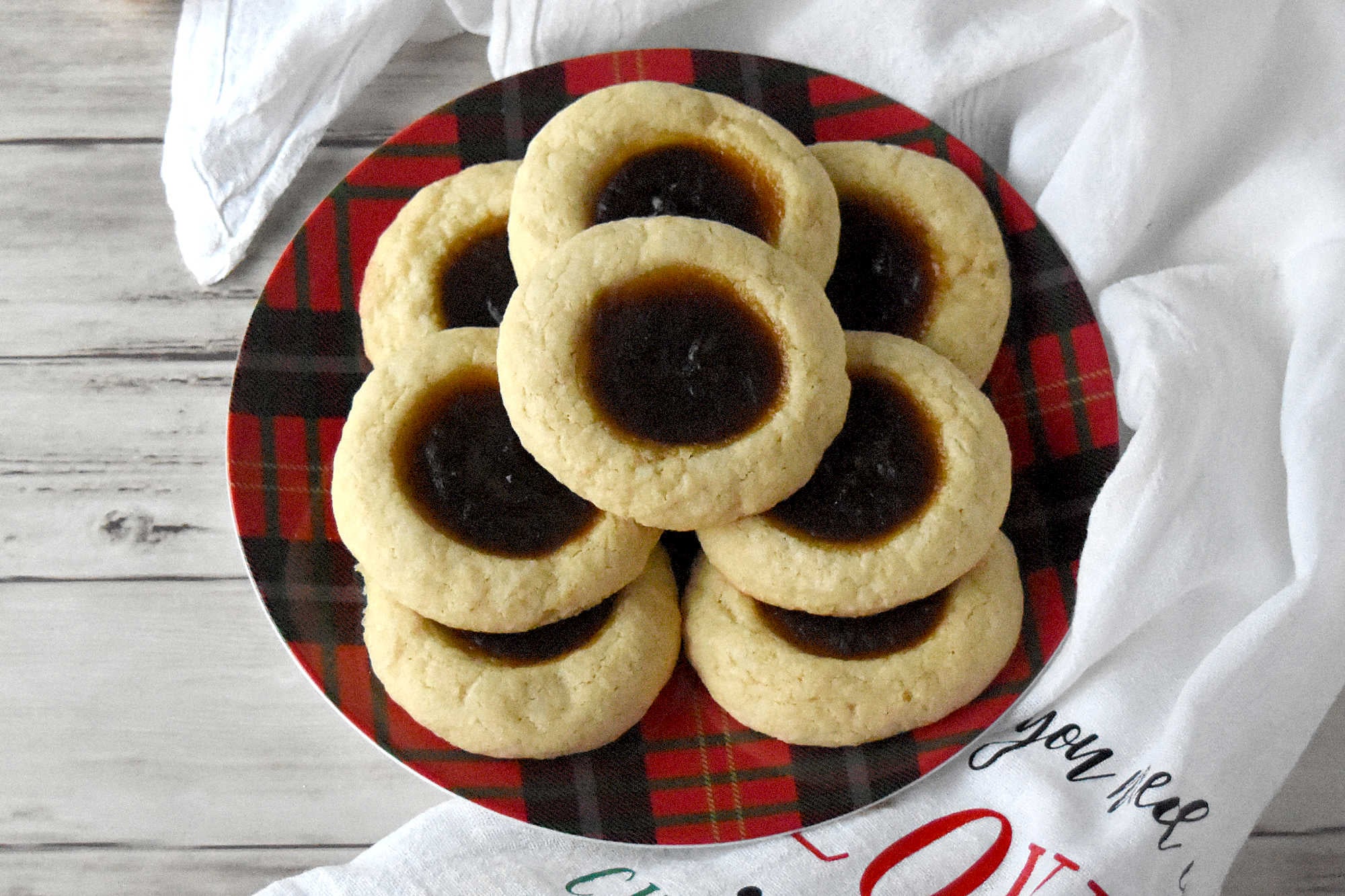 Pumpkin Pie Thumbprint Cookies take everything you love about holiday desserts and pack it into a sweet, bite sized treat.  They are perfect for anyone who cannot decide between pie and cookies. #ChristmasCookies #PumpkinPieThumbprintCookies #FallBakingDelights #HolidayBakingGoals #CookieLoversUnite #EasyDessertRecipes