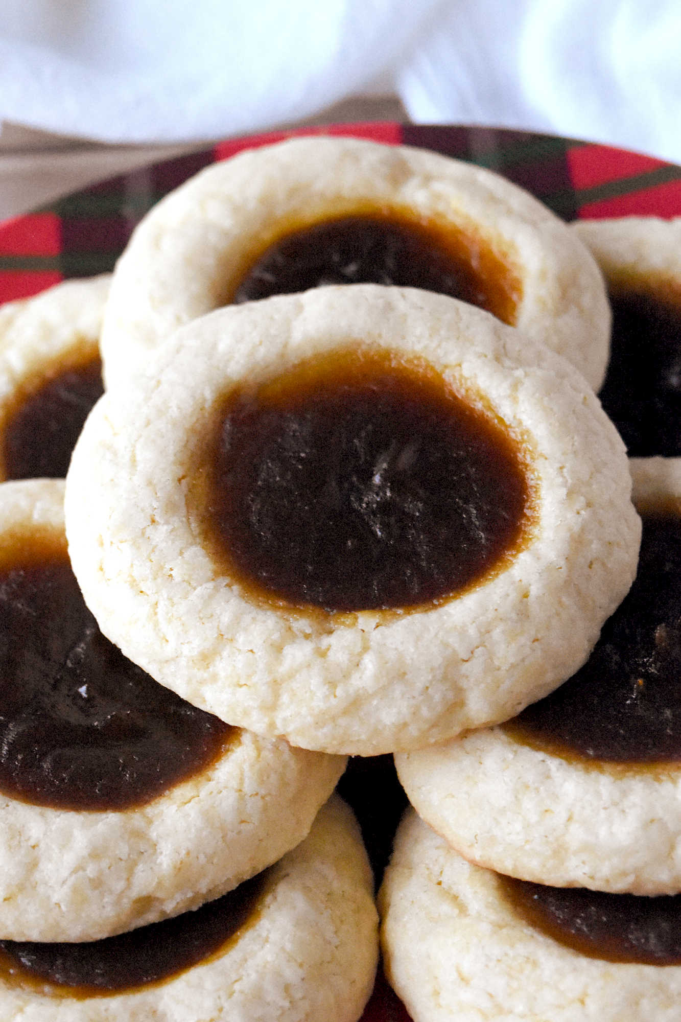 Pumpkin Pie Thumbprint Cookies take everything you love about holiday desserts and pack it into a sweet, bite sized treat.  They are perfect for anyone who cannot decide between pie and cookies. #ChristmasCookies #PumpkinPieThumbprintCookies #FallBakingDelights #HolidayBakingGoals #CookieLoversUnite #EasyDessertRecipes