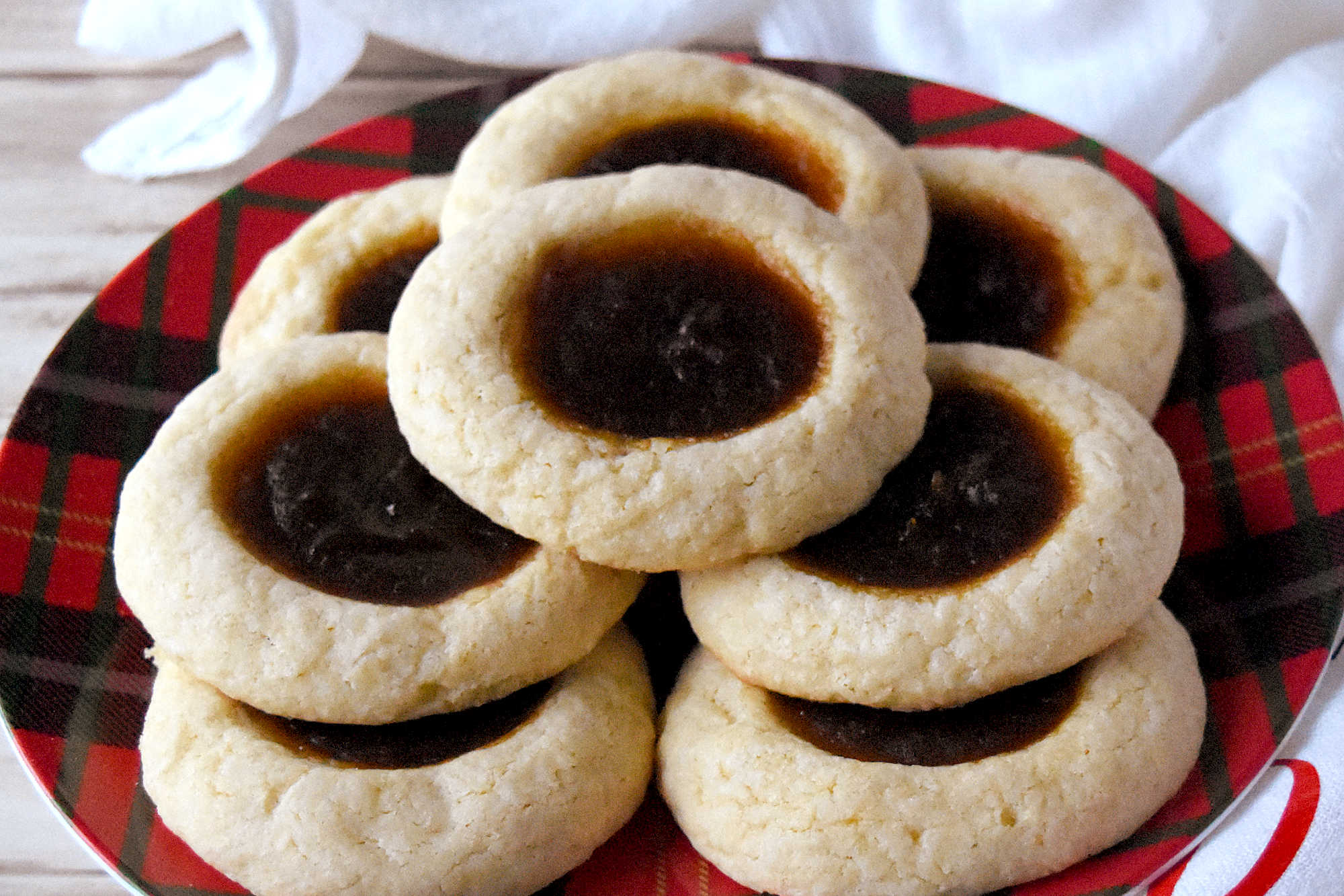 Pumpkin Pie Thumbprint Cookies take everything you love about holiday desserts and pack it into a sweet, bite sized treat.  They are perfect for anyone who cannot decide between pie and cookies. #ChristmasCookies #PumpkinPieThumbprintCookies #FallBakingDelights #HolidayBakingGoals #CookieLoversUnite #EasyDessertRecipes