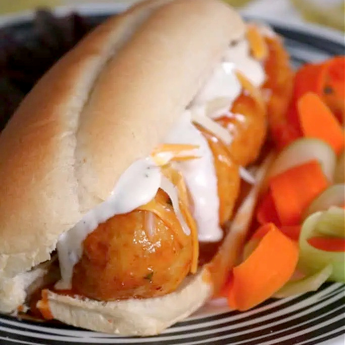 Taste buds will love these juicy baked Buffalo chicken meal subs topped with more Buffalo sauce and melty cheese. But are you picking ranch or blue cheese dressing?