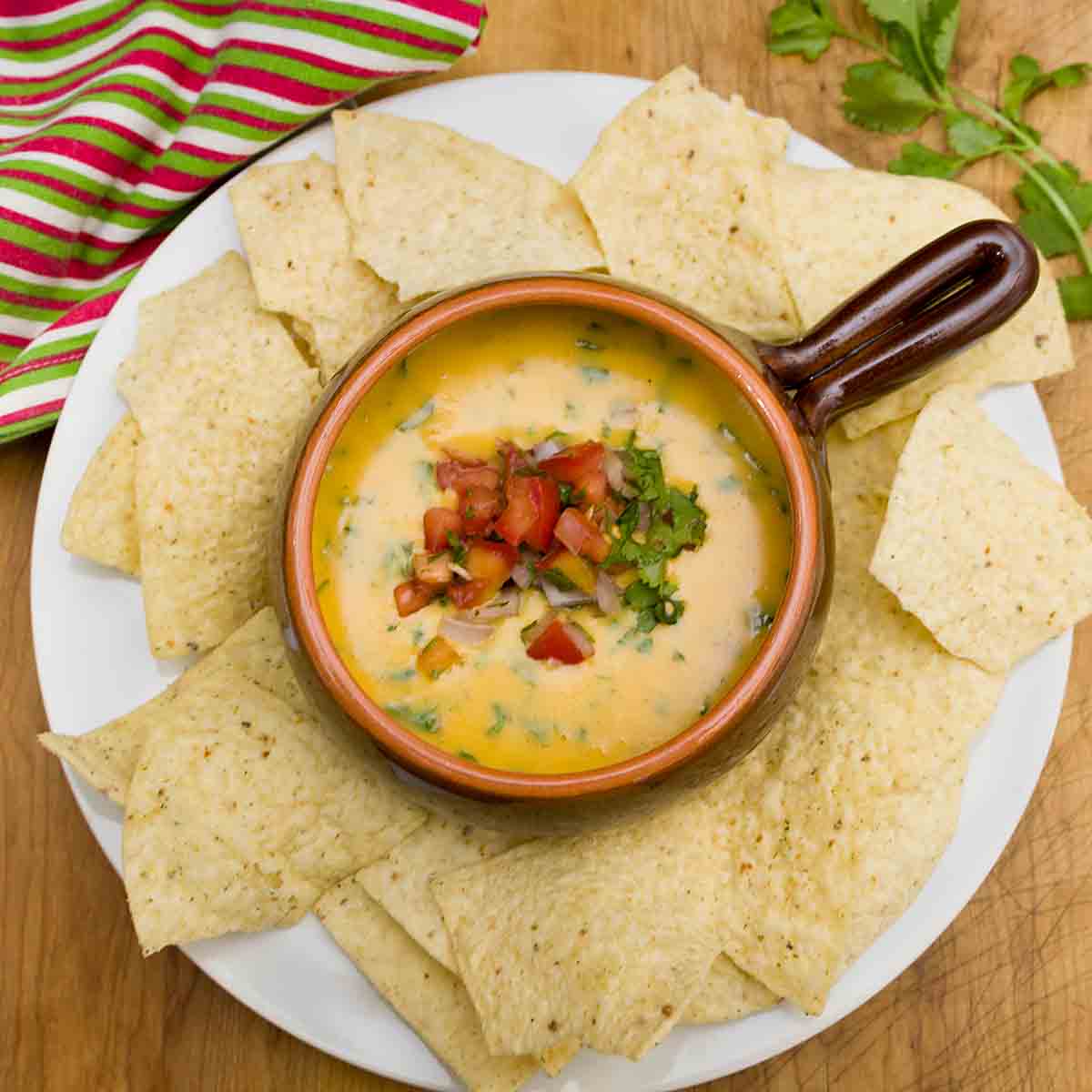 Ready in about 15 minutes, this easy Queso Dip is a tasty appetizer or snack.  Perfect for Game Day, Cinco de Mayo or any occasion!