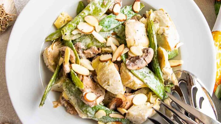 This artichoke salad with pea pods, mushrooms and toasted almonds in a creamy dill dressing is easy and tasty.  Move over lettuce salad!