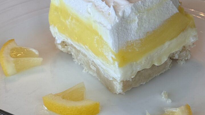Lemon Lush is perfect for your next spring gathering with a cookie crust, cream cheese layer, lemon filling and creamy whipped topping.