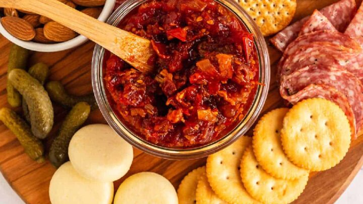 Tomato Bacon Jam is bursting with savory sweet flavor and chunks of bacon. Ripe tomatoes, onions, and bacon are slow simmered until jammy!
