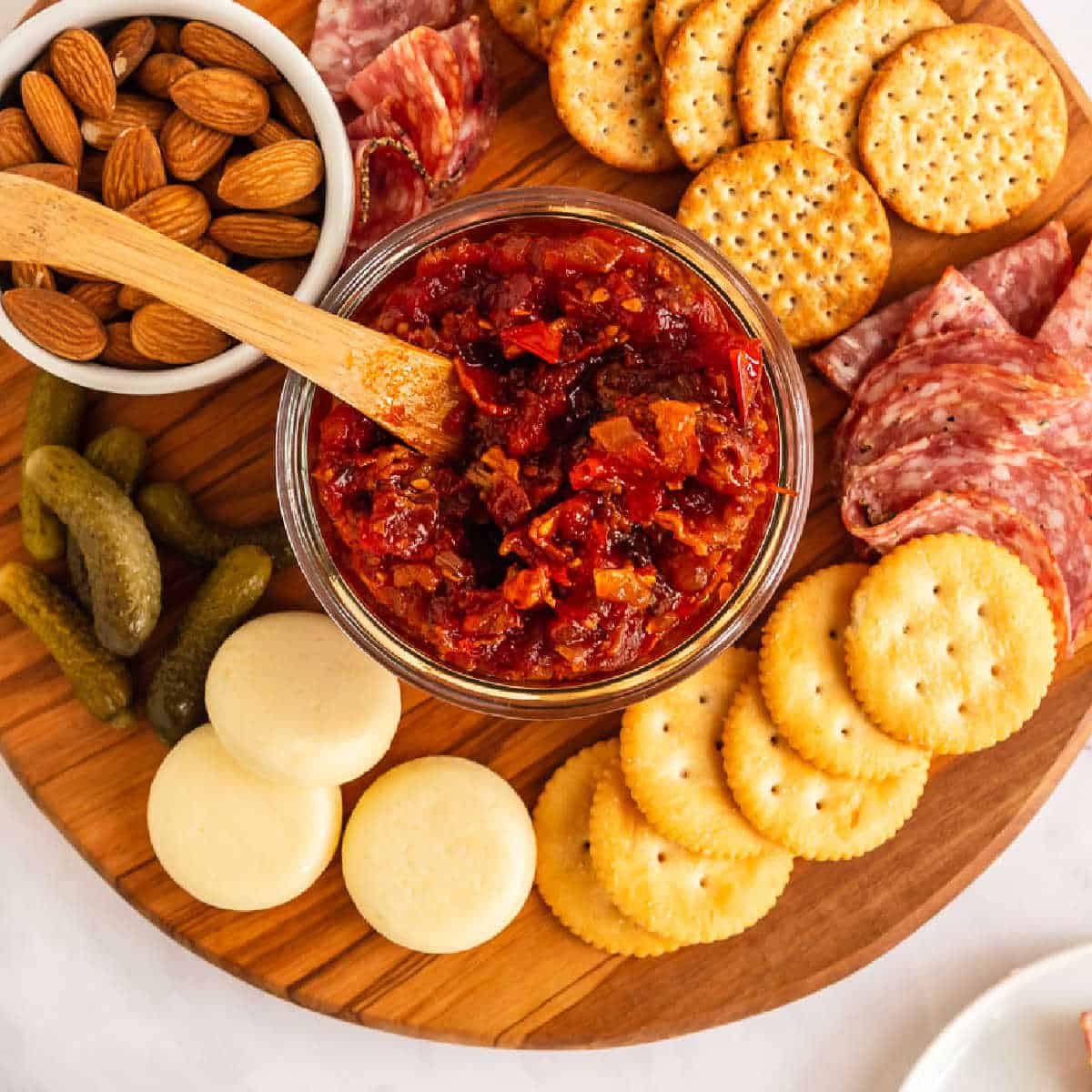 Tomato Bacon Jam is bursting with savory sweet flavor and chunks of bacon. Ripe tomatoes, onions, and bacon are slow simmered until jammy!
