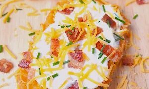 Easy loaded hash brown patties baked crispy and topped with cheese, bacon, and sour cream. A quick and easy brunch or breakfast recipe.